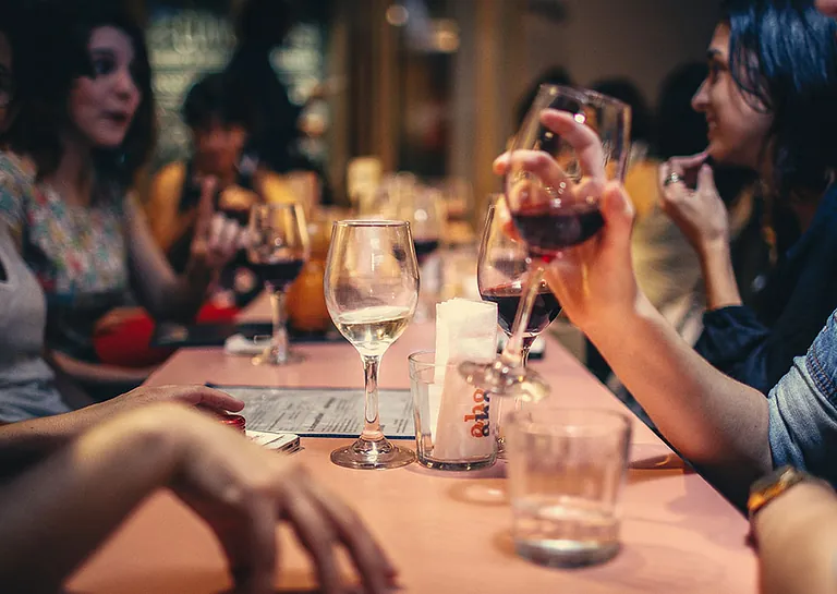 a group of people celebrating with drinks